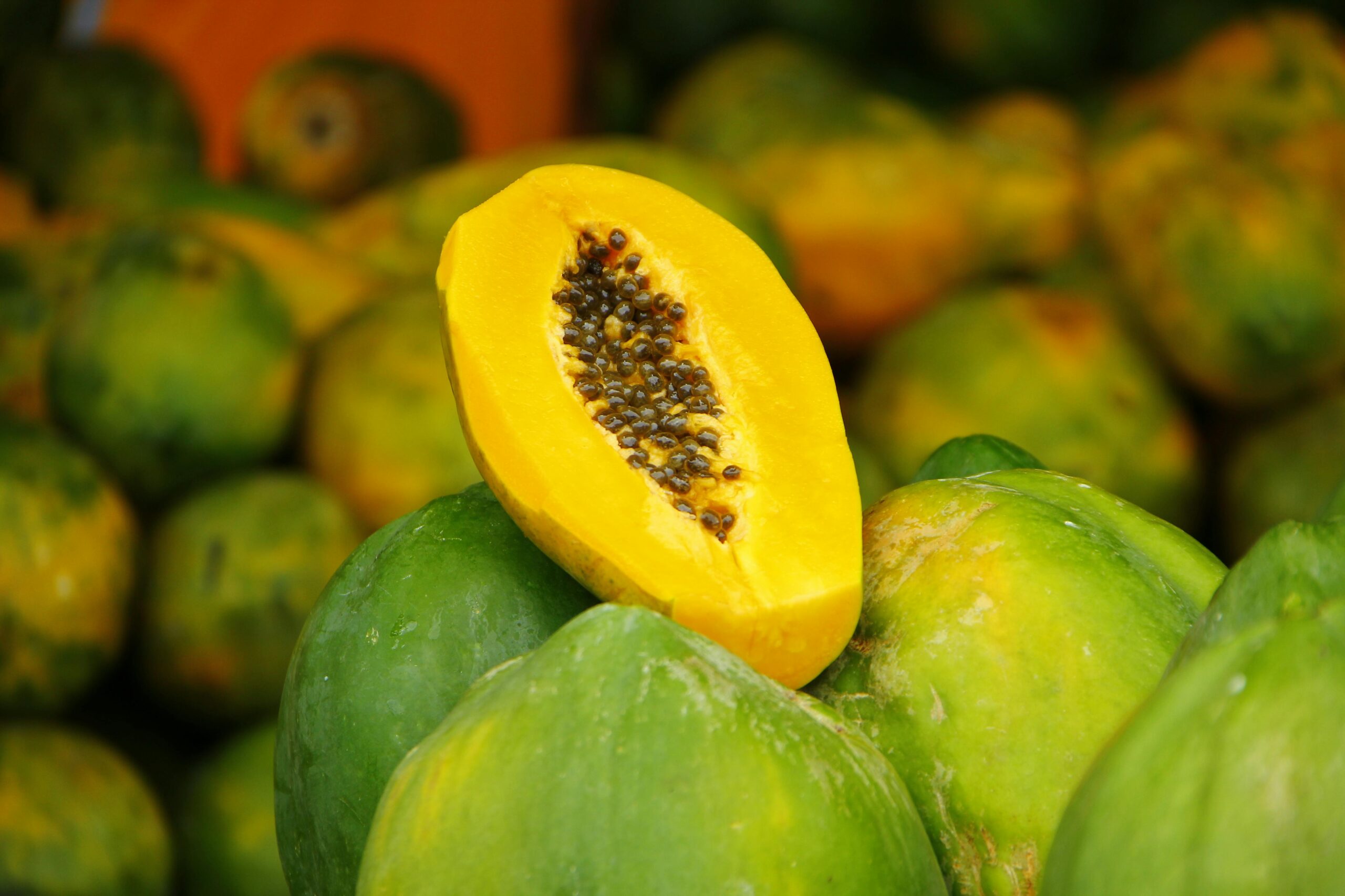 Close-up of vibrant sliced papaya with seeds. Perfect for healthy eating concepts.